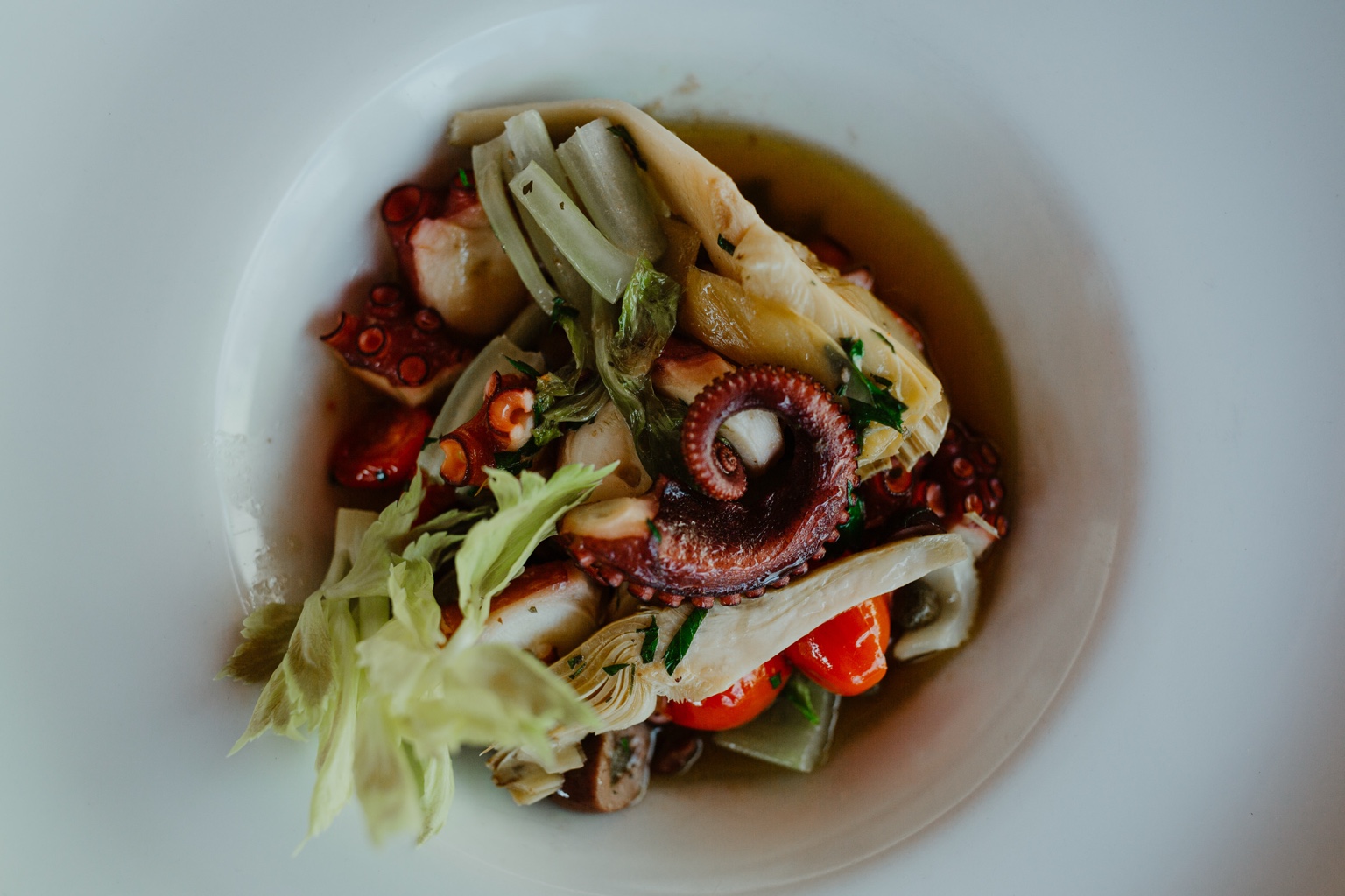 A PepeNero octopus dish with artichokes and seasonal vegetables